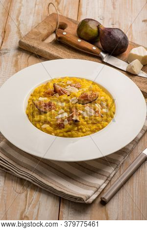 milanese risotto with cheese fig and sliced almond
