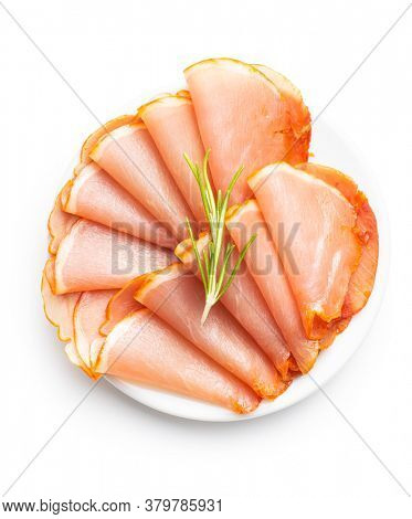 Dried spanish ham on plate. Lomo embuchado isolated on white background.