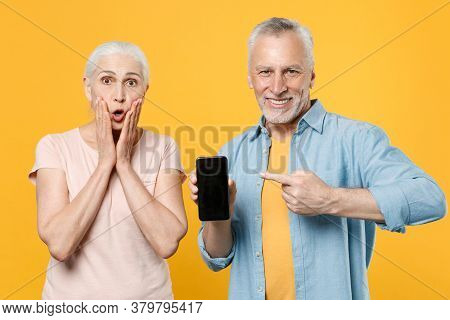Shocked Elderly Gray-haired Couple Woman Man In Casual Clothes Isolated On Yellow Background. People