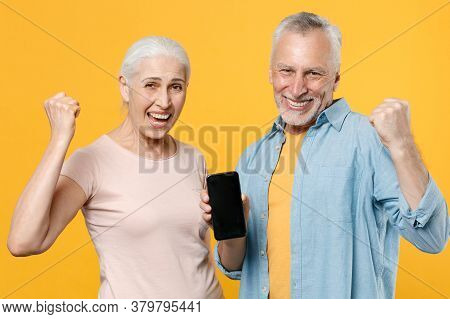 Happy Elderly Gray-haired Couple Woman Man In Casual Clothes Isolated On Yellow Background Studio Po