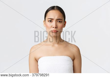 Upset And Disappointed Asian Girl Complaining Bad Spa Salon Services, Standing In Towel And Grimacin