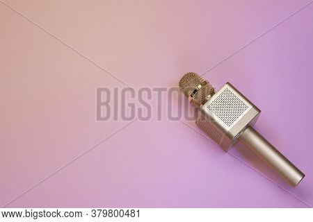 Gold Karaoke Microphone On Pink Background, Top View. Karaoke Microphone Recording Concept A Microph