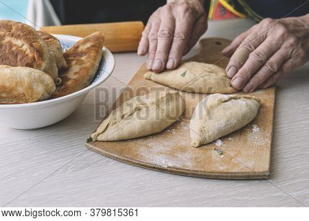 Grandma Cooks Pies. Home Cooked Food. Omemade Cakes Of The Dough In The Womens Hands. Process Of Mak
