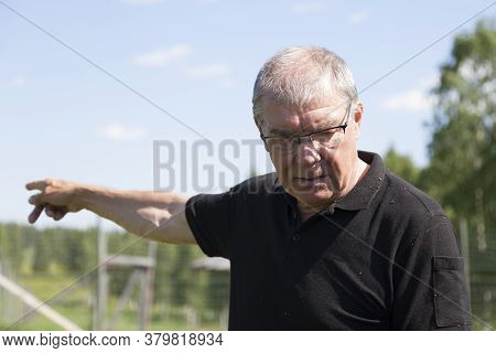 Bjurholm, Norrland Sweden - July 6, 2020: Older Man Points Out Direction