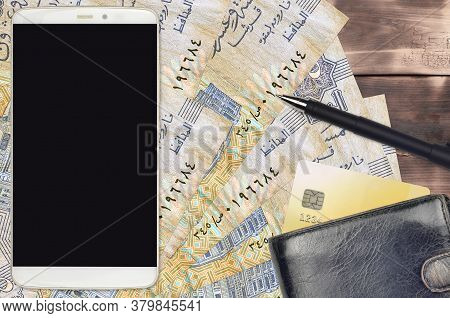 25 Egyptian Piastres Bills And Smartphone With Purse And Credit Card. E-payments Or E-commerce Conce