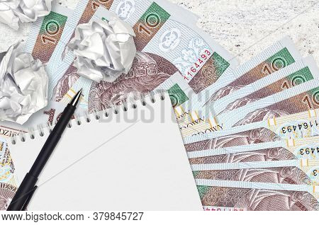10 Polish Zloty Bills And Balls Of Crumpled Paper With Blank Notepad. Bad Ideas Or Less Of Inspirati