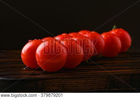 Red Tomatoes With Water Droplets On A Dark Background
