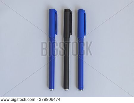 Blue And Black Penes On A White Background