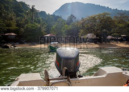 The Stern And Outboard Motor Of A Boat Leaving A Tropical Island In Morning, Tiomen Island, Malaysia