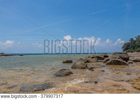 A Rocky Shore At Melina Beach On A Sunny Day, On The Tropical Island Of Tiomen Island, Malaysia