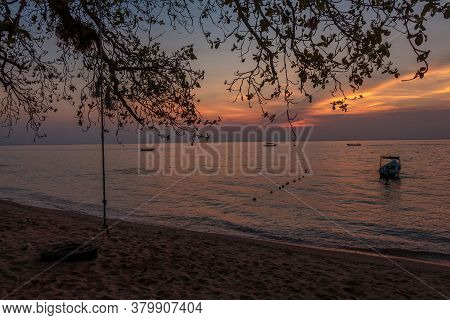 Rope Swing And Boat At Sunset On Melina Beach, Tiomen Island