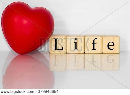 Red Heart. Healthcare And Medicine With Media Icons Concept, Wooden Cube With The Inscription Life.