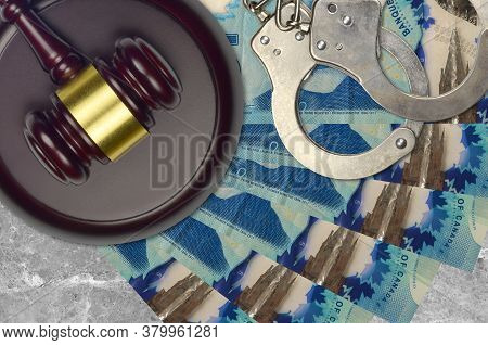 5 Canadian Dollars Bills And Judge Hammer With Police Handcuffs On Court Desk. Concept Of Judicial T