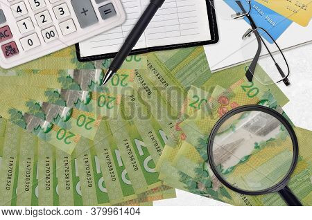 20 Canadian Dollars Bills And Calculator With Glasses And Pen. Tax Payment Season Concept Or Investm