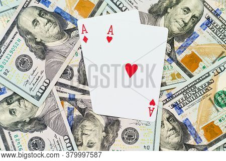 Playing Cards On Us Dollars Background. Close Up Of A Lot Of Banknotes Hundred Dollar Bills. America