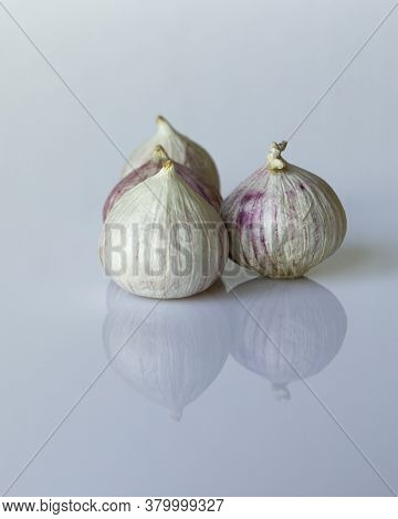 Fresh Solo Garlic Bulbs Which Are Used For Cooking On A White Background. They Are Grown In Asia