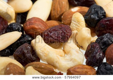 mixed nuts and dried fruits isolated on white background