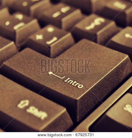 closeup of the intro key of a computer keyboard, with a retro effect
