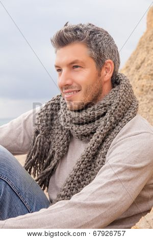 man relaxing coast in colder season