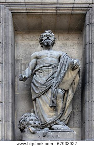 PARIS, FRANCE - NOV 09, 2012: Saint Mark the Evangelist, architectural details of Eglise de la Madeleine. Madeleine Church was designed in its present form as a temple to the glory of Napoleon's army.