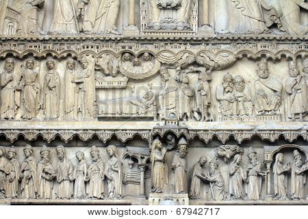 PARIS, FRANCE - NOV 05, 2012: Notre Dame cathedral. Portal of St. Anne. Upper lintel depicts scenes from the advent of Christ, lower tells the stories of Anne and Joachim and Mary and Joseph