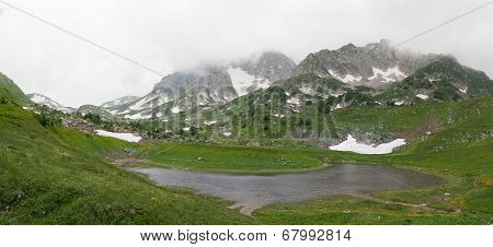 Lake Psenodah and mountains Pshekha-Su in cloudy weather