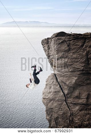businessman fall from cliff sea background
