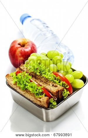Lunch box with sandwiches, fruits  and water on white background