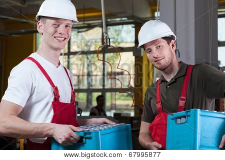 Storekeepers Holding Crates With Finished Goods