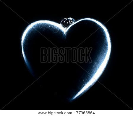 Heart shape emerging from a black background.