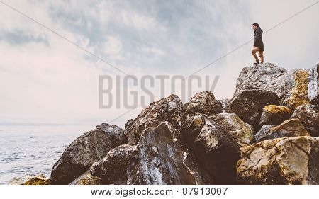 Woman Standing On Stone Near The Sea