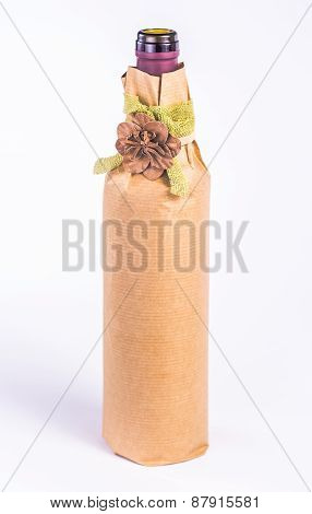 isolated bottle wrapped in paper with decorative flower