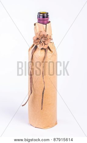 isolated bottle wrapped in paper with decorative flower