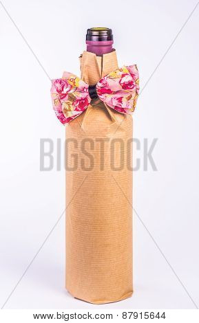 isolated bottle wrapped in paper with decorative bow