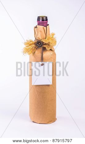 one bottle wrapped in paper decorative bow and blank card