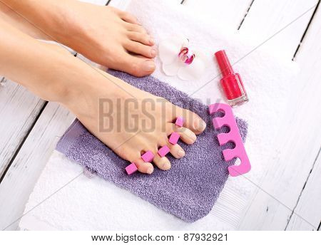 Purple pedicure, groomed female foot