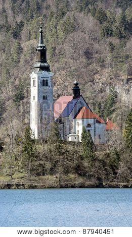 Ancient Church With A High Bell Tower On The Island On Lake Bled
