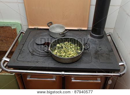 Pot With Cooked Zucchini In The Ancient Stove With Fire Lit