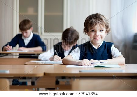 Diligent Student Sitting At Desk, Classroom