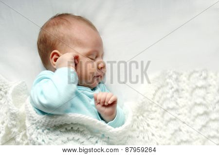 Sleeping Newborn Baby Girl In White Blankets