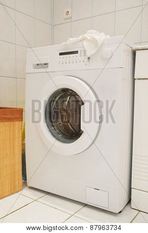 The image of washing machine at the bathroom 