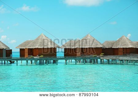 Water villas over blue ocean in Baros Maldives