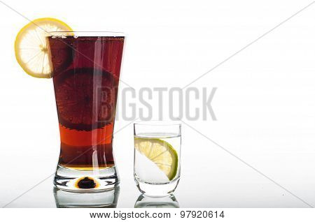 Glass Of Cola With Sliced Lemon And Shot Of Vodka