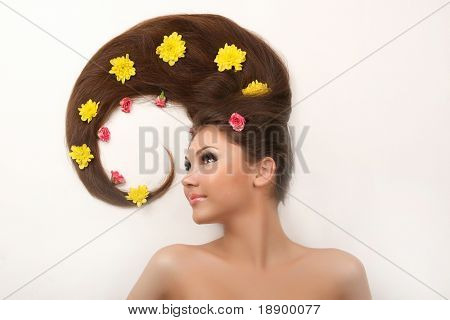 portrait of young woman with beautiful hair covered with flowers isolated on white
