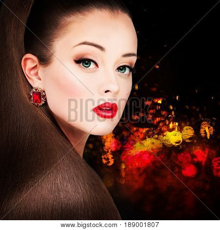 Glamorous Woman Fashion Model with Long Hairstyle Red Lips Makeup and Earrings on Night Party Background