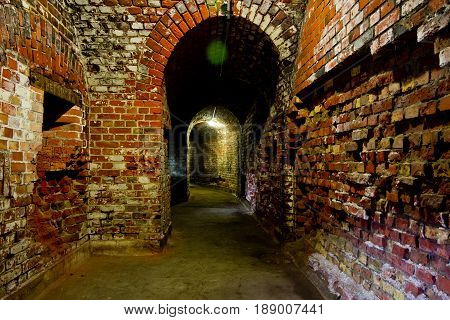 Arched corridor of the old German fortification structure of red brick