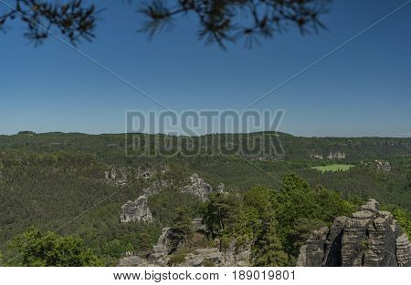 Big rocks near Bastei bridge in valley of river Elbe or Labe in spring sunny day