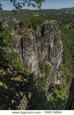Big rocks near Bastei bridge in valley of river Elbe or Labe in spring sunny day