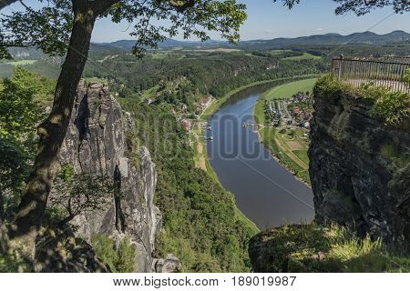 Big rocks near Bastei bridge in valley of river Elbe or Labe in spring sunny day