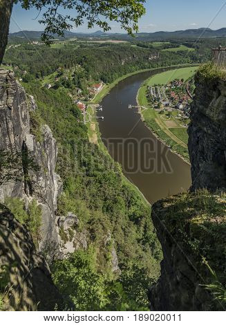 Big rocks near Bastei bridge in valley of river Elbe or Labe in spring sunny day